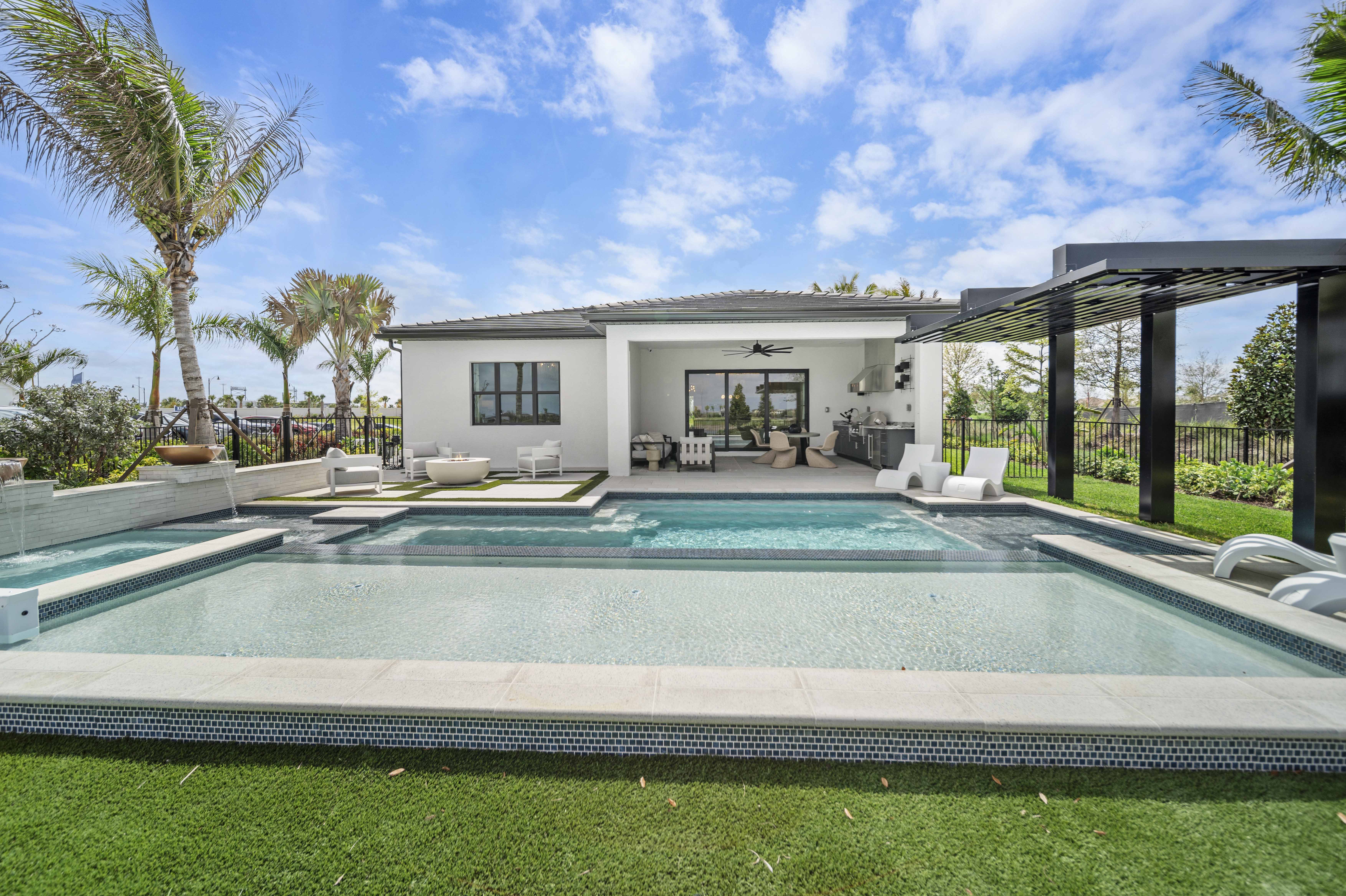 Completed luxury pool at golden hour with warm amber light and architectural stone deck