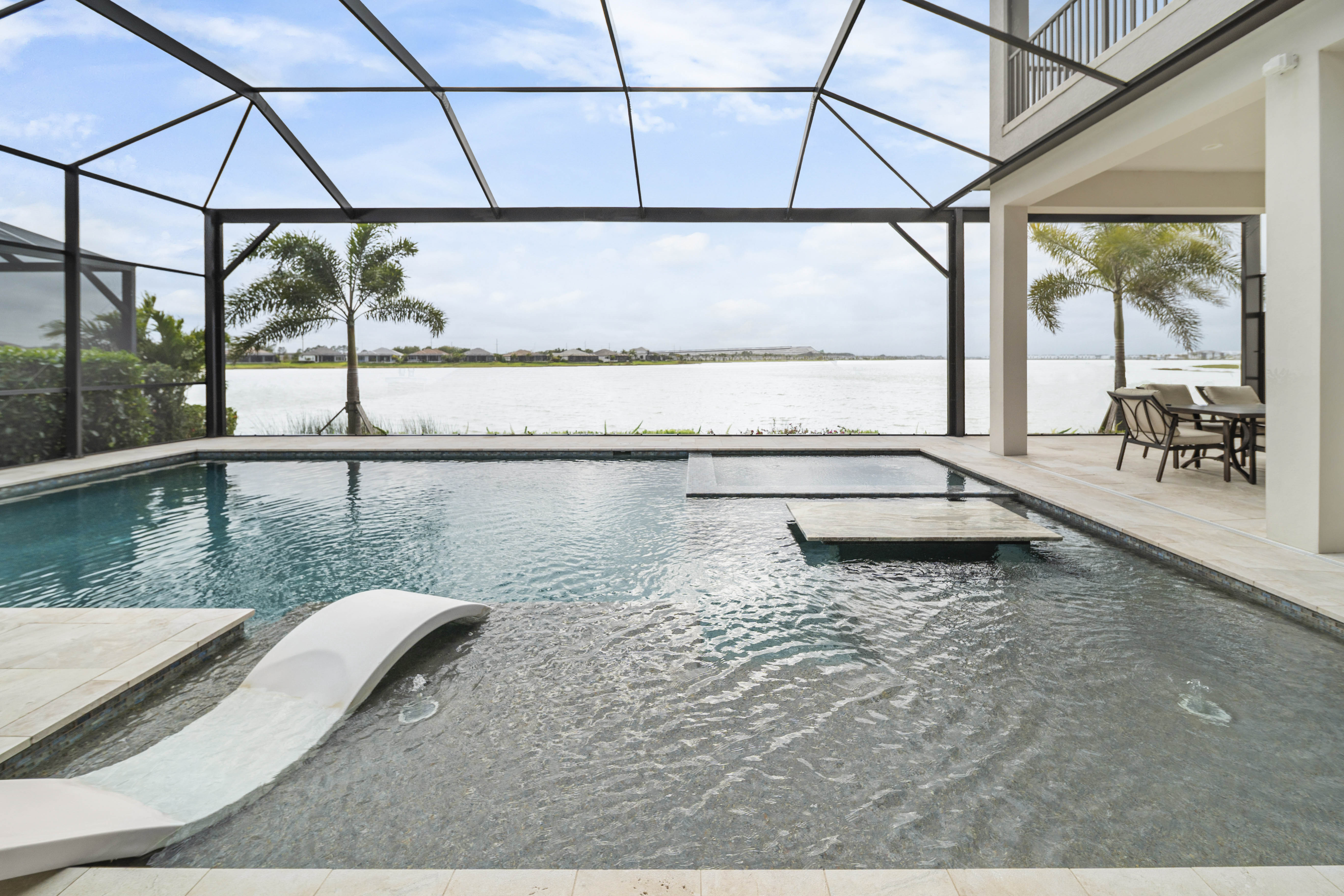 Full panoramic of resort outdoor environment at blue hour with swim-up table and covered lanai, Sarasota, FL, Swim Inc.