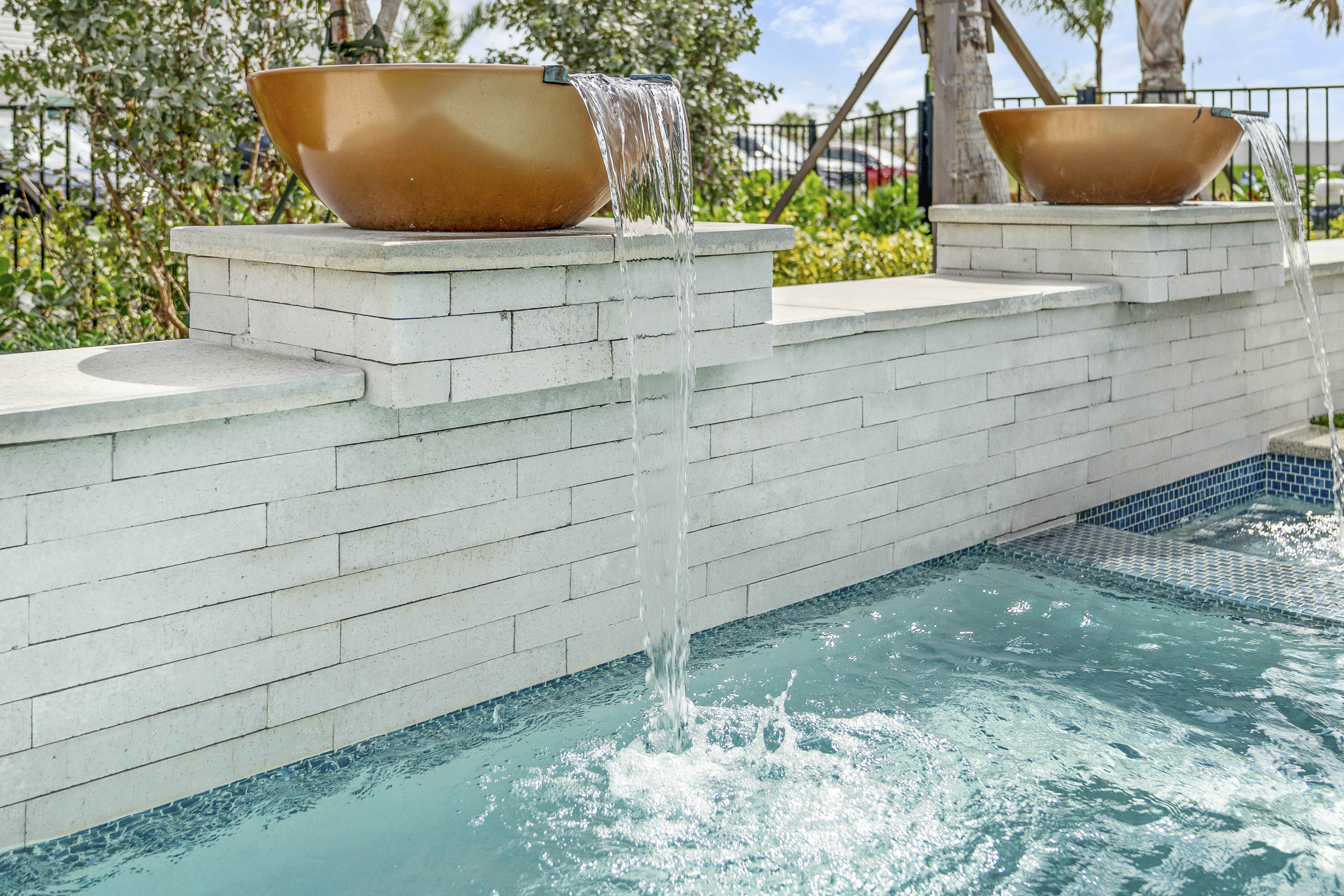 Geometric modern pool at dusk with LED underwater lighting and water bowls in Venice, FL, Swim Inc.