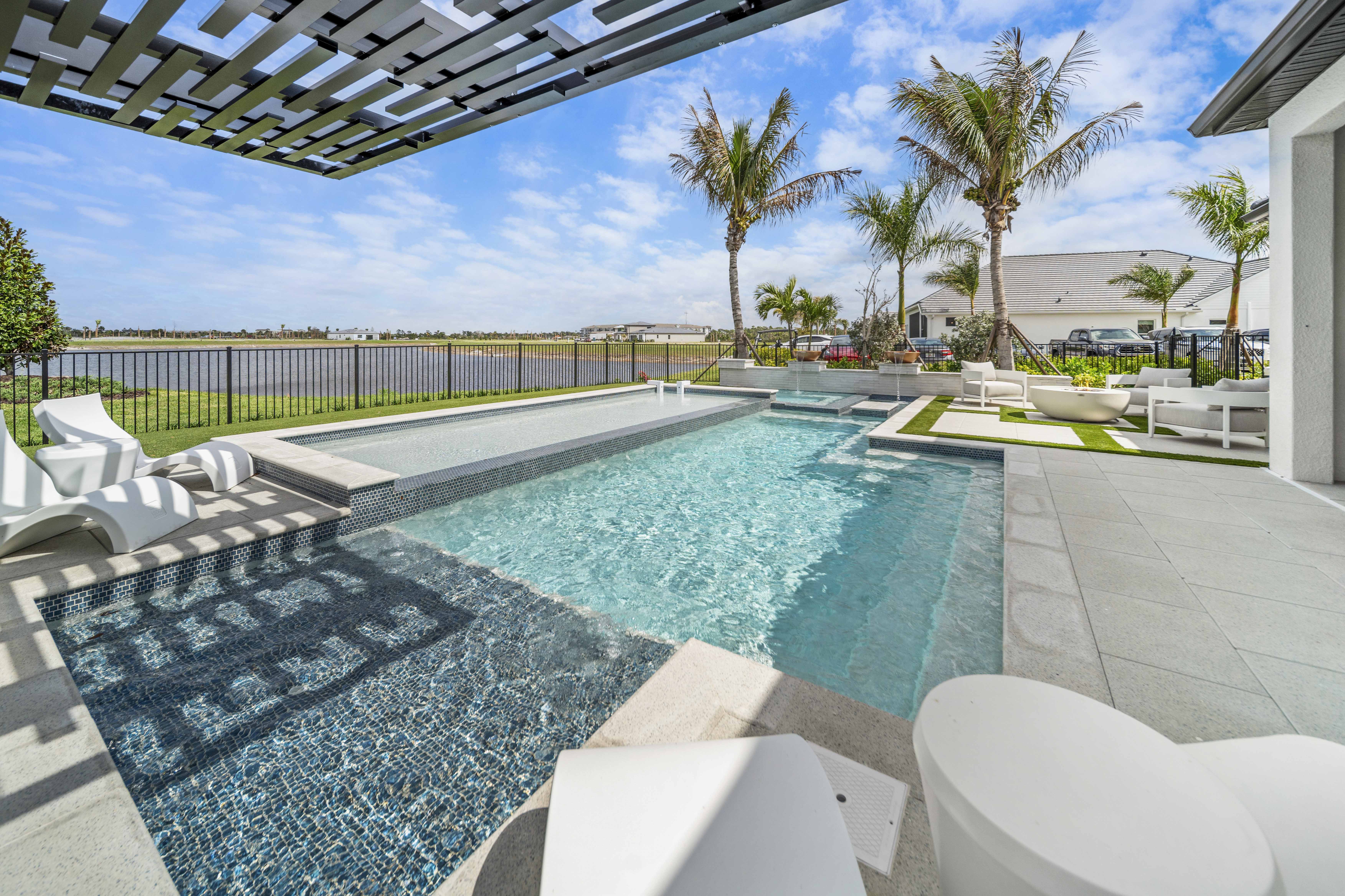 The Snellings' completed custom pool in Lakewood Ranch with spa and sun shelf at warm evening light