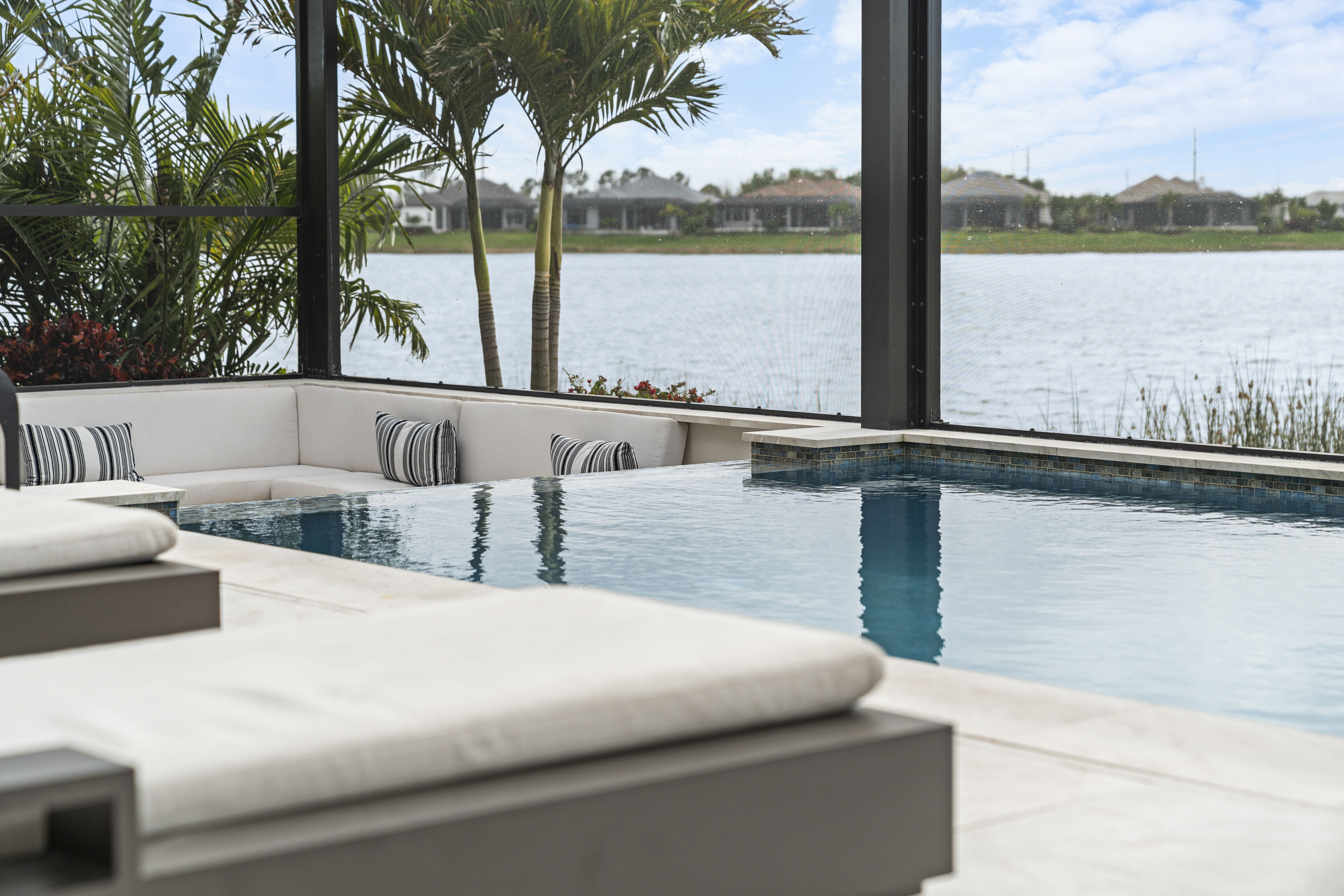 Custom vanishing edge pool by Swim Inc. on Siesta Key, FL - twilight photograph showing Gulf-adjacent waterfront pool with LED lighting