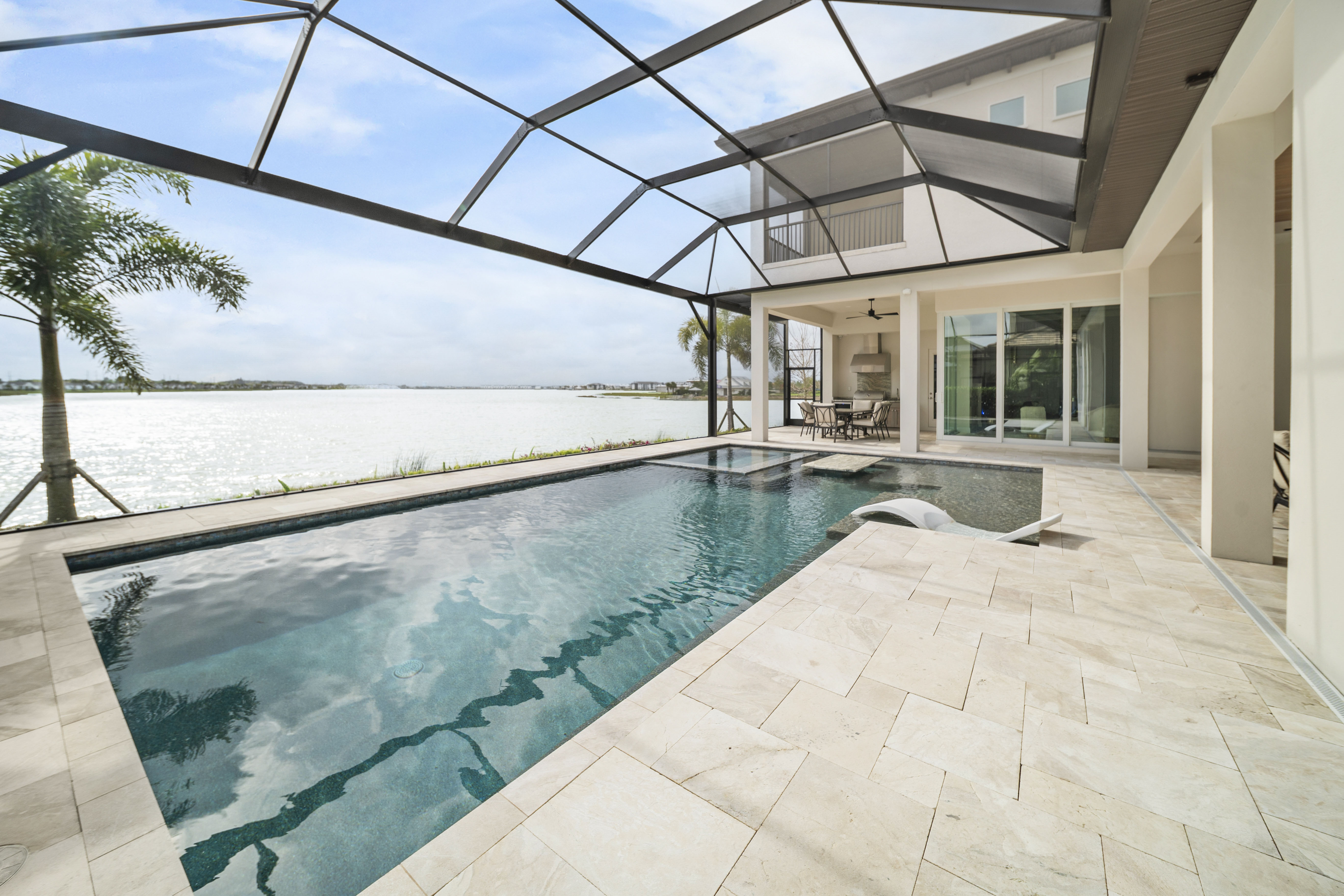 Custom pool by Swim Inc. in Venice, FL - resort-quality pool with spa and tropical landscaping at twilight